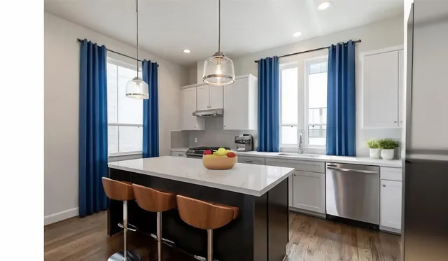a kitchen with a table chairs and wooden floor