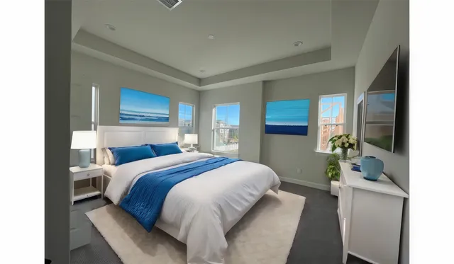 a bedroom with a bed table and two mirrors