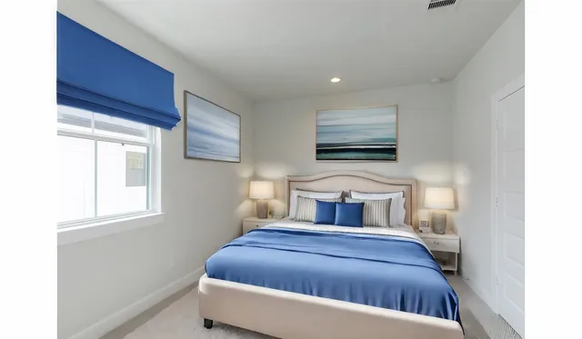 a bedroom with a bed and window