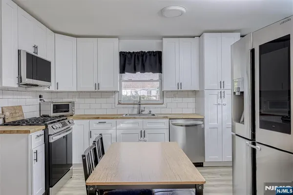 a kitchen with a stove a sink and a refrigerator