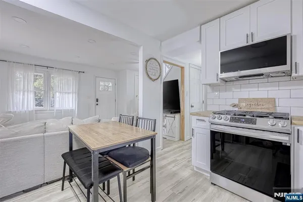 a view of kitchen with cabinets and wooden floor