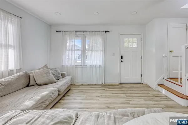 a bedroom with a bed a couch and a window