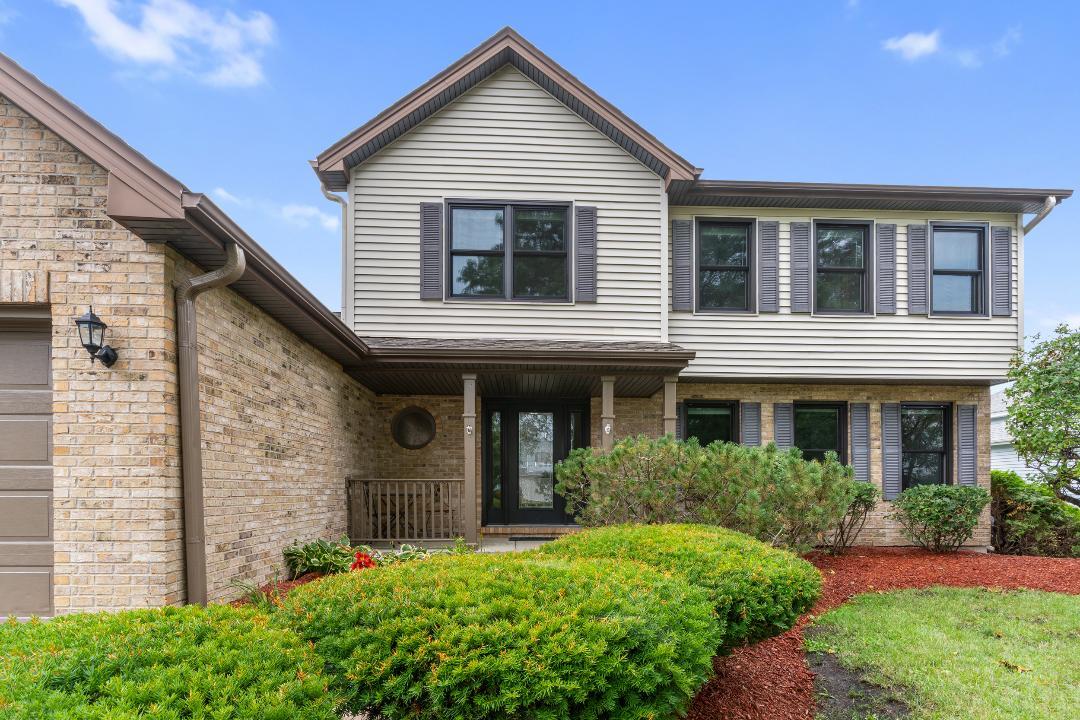 1715 Chestnut Hill Road Plainfield, IL 60586 - Photo 1 of 16 a view of a house with brick walls and a yard with plants