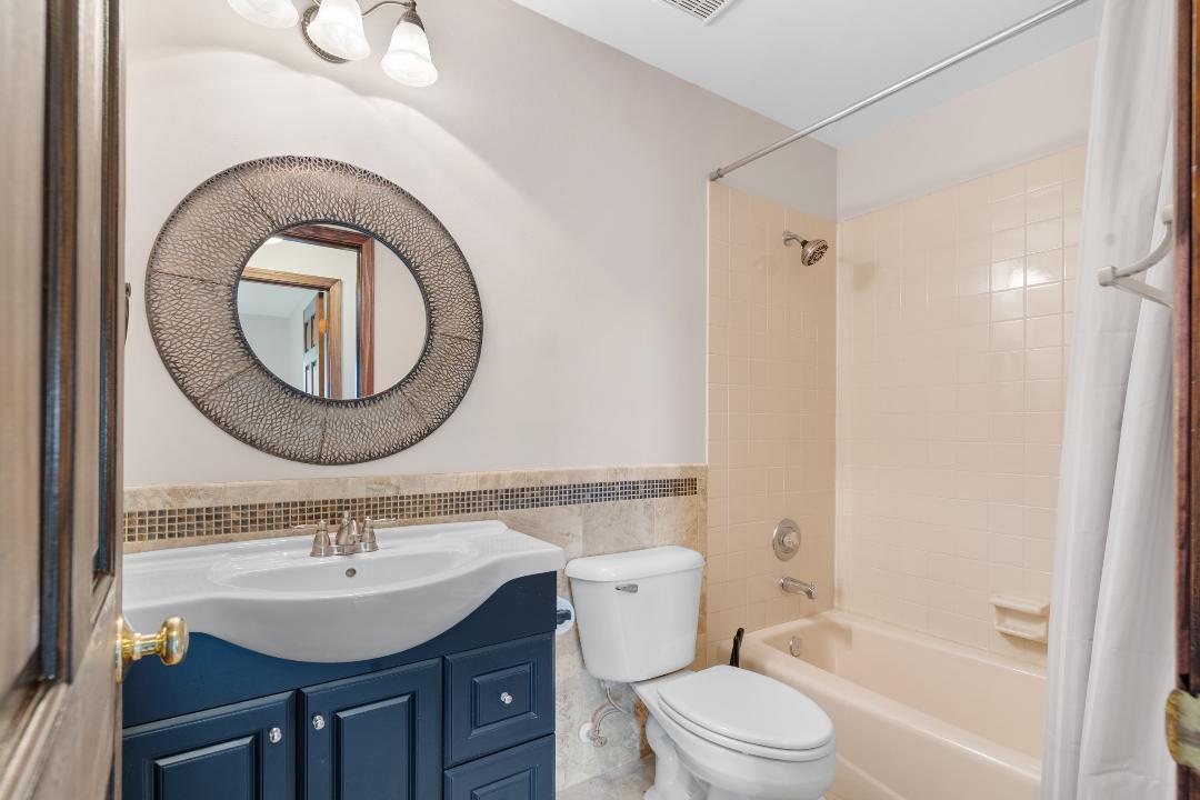 1715 Chestnut Hill Road Plainfield, IL 60586 - Photo 15 of 16 a bathroom with a sink a toilet and a mirror