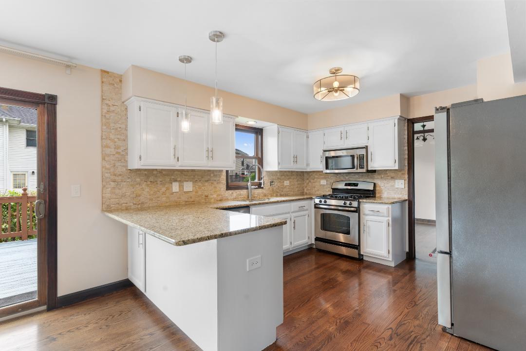 1715 Chestnut Hill Road Plainfield, IL 60586 - Photo 6 of 16 a kitchen with a refrigerator sink and cabinets