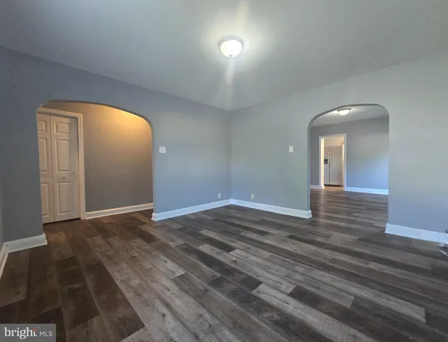 a view of an empty room and wooden floor