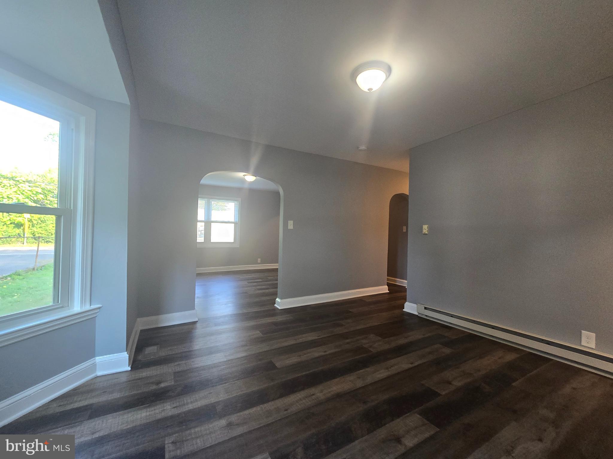 151 Riviera Drive Pasadena, MD 21122 - Photo 16 of 72 an empty room with wooden floor and windows
