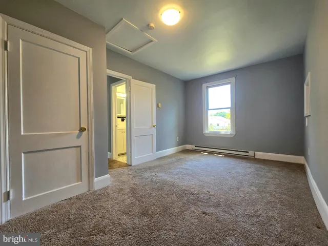 a kitchen with a sink cabinets and a window