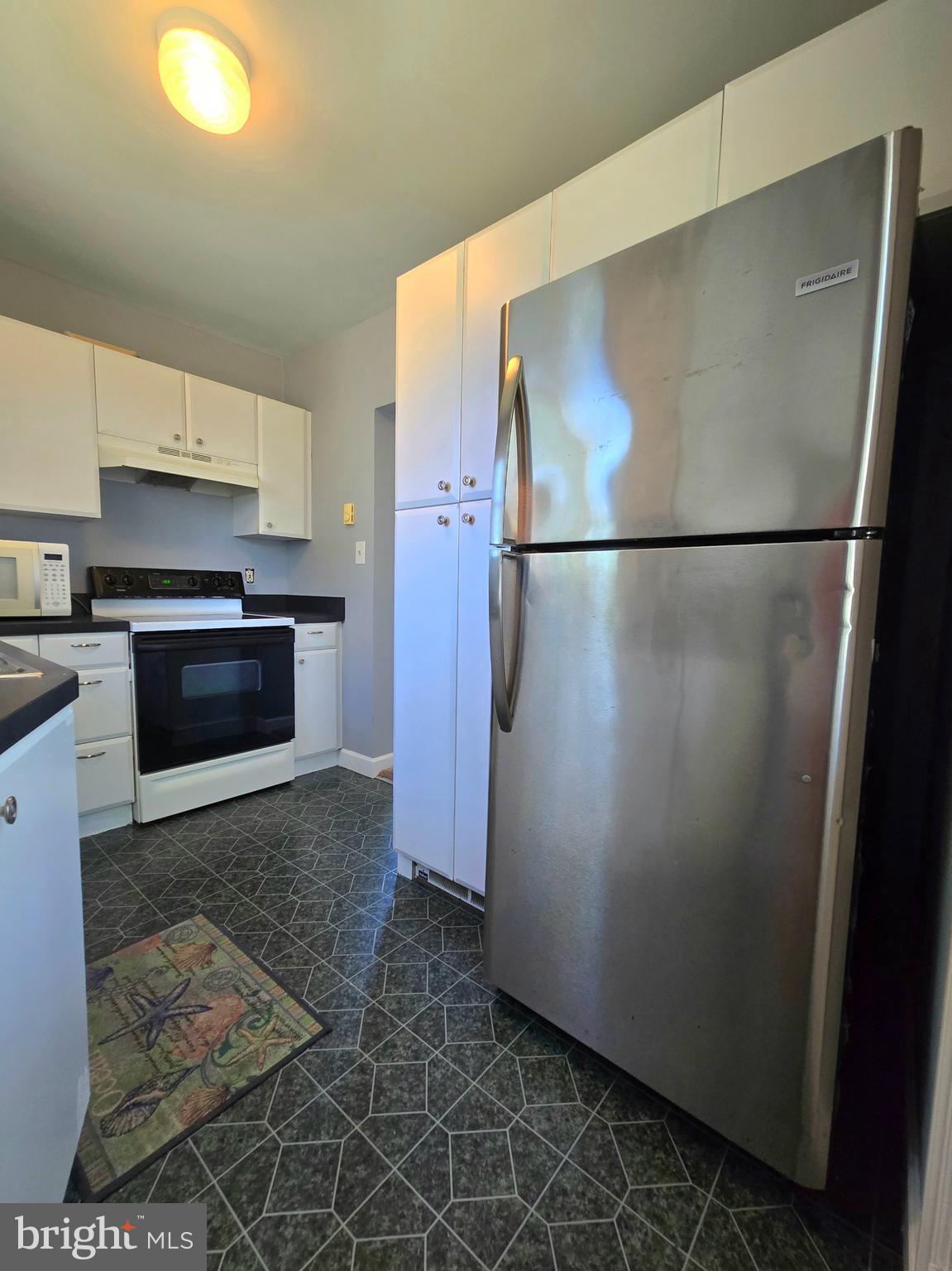 151 Riviera Drive Pasadena, MD 21122 - Photo 40 of 72 a kitchen with stainless steel appliances granite countertop a refrigerator and a stove