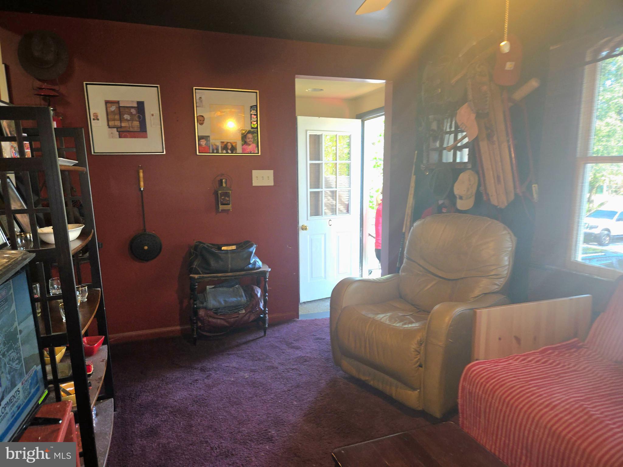 151 Riviera Drive Pasadena, MD 21122 - Photo 45 of 72 a living room with furniture a lamp and a window