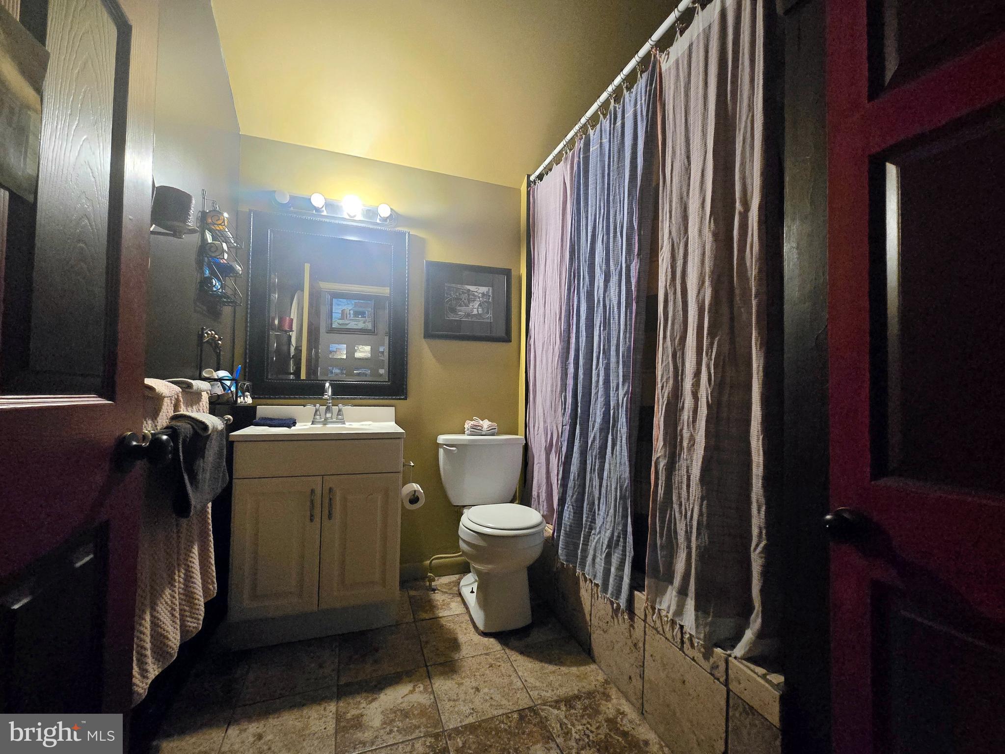 151 Riviera Drive Pasadena, MD 21122 - Photo 51 of 72 a bathroom with a sink a toilet and shower