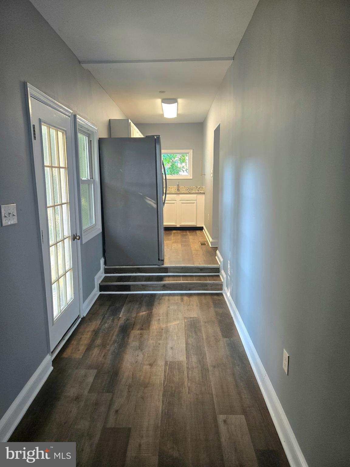 151 Riviera Drive Pasadena, MD 21122 - Photo 6 of 72 a view of an empty room with wooden floor and a window