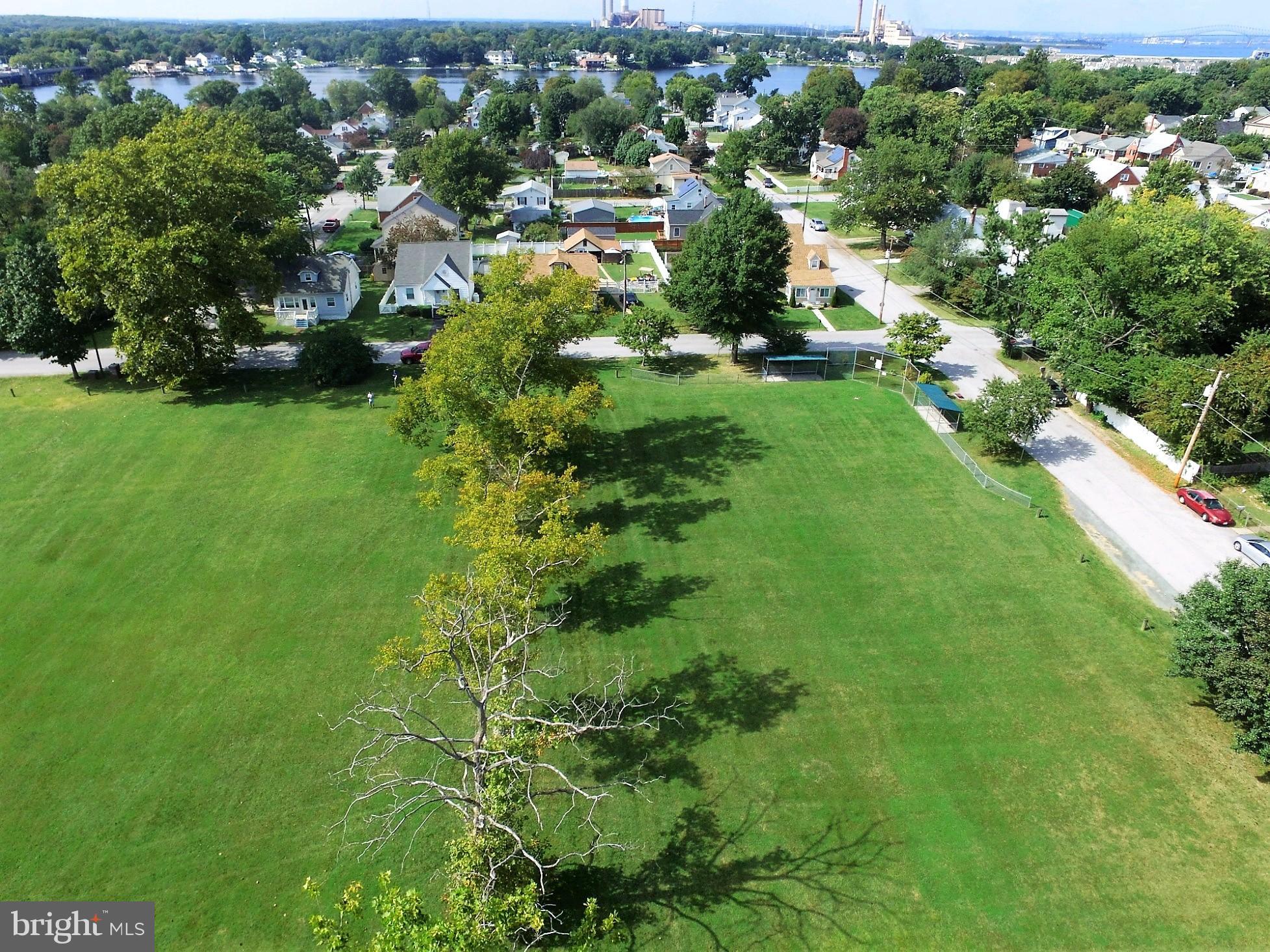 151 Riviera Drive Pasadena, MD 21122 - Photo 65 of 72 a view of a green yard with large trees