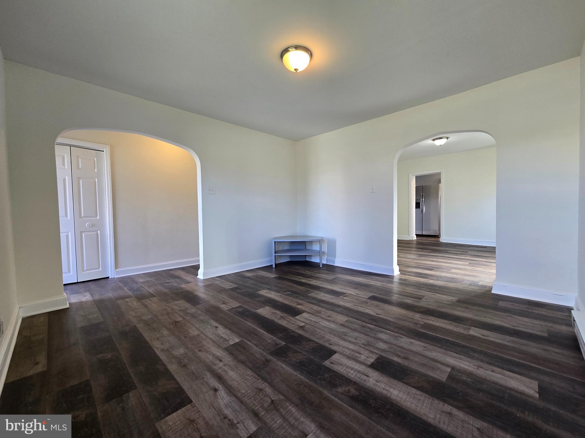 151 Riviera Drive Pasadena, MD 21122 - Photo 8 of 66 a view of a big room with wooden floor and windows