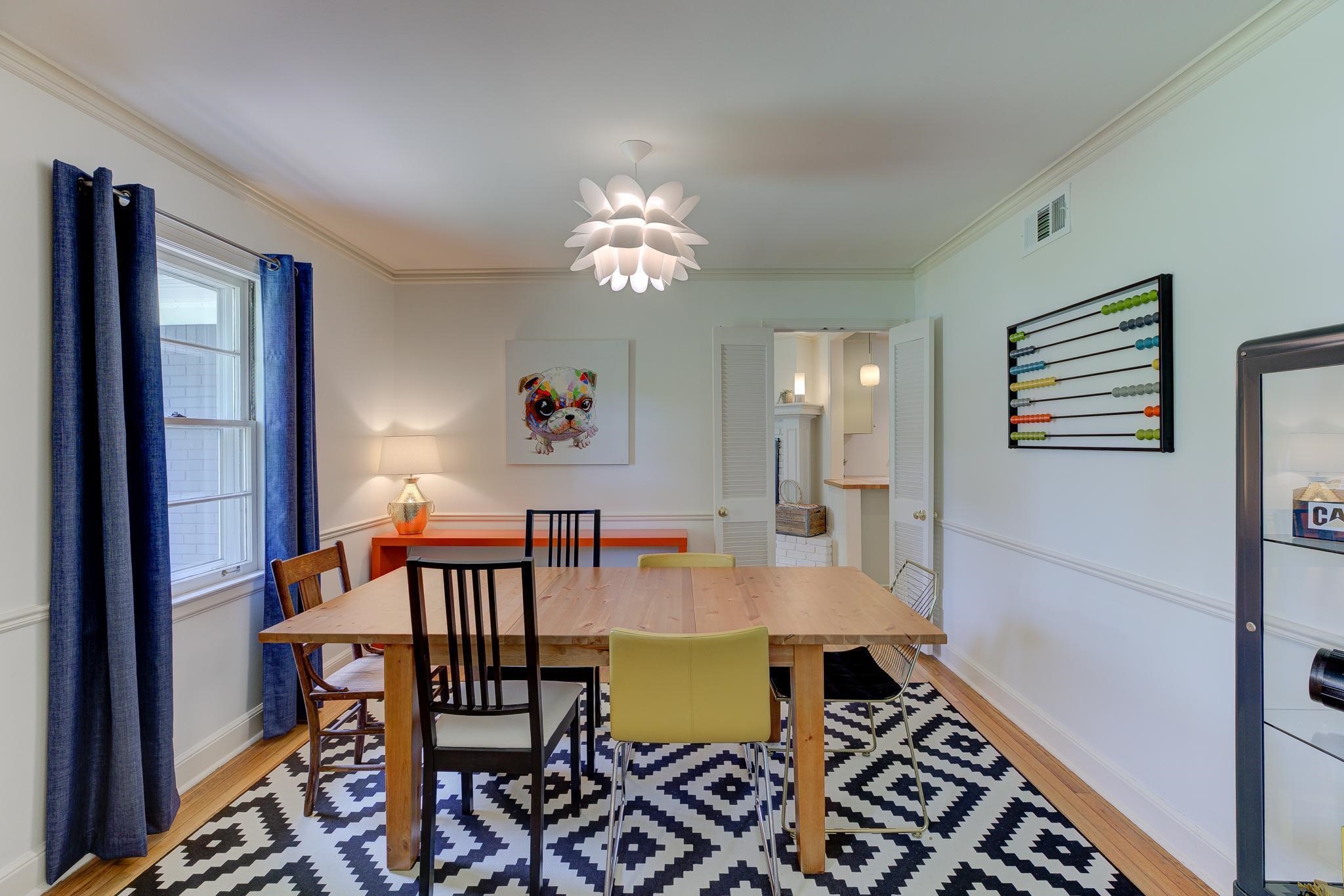 264 North Rose Road Memphis, TN 38117 - Photo 4 of 25 a view of a dining room with furniture a chandelier and wooden floor