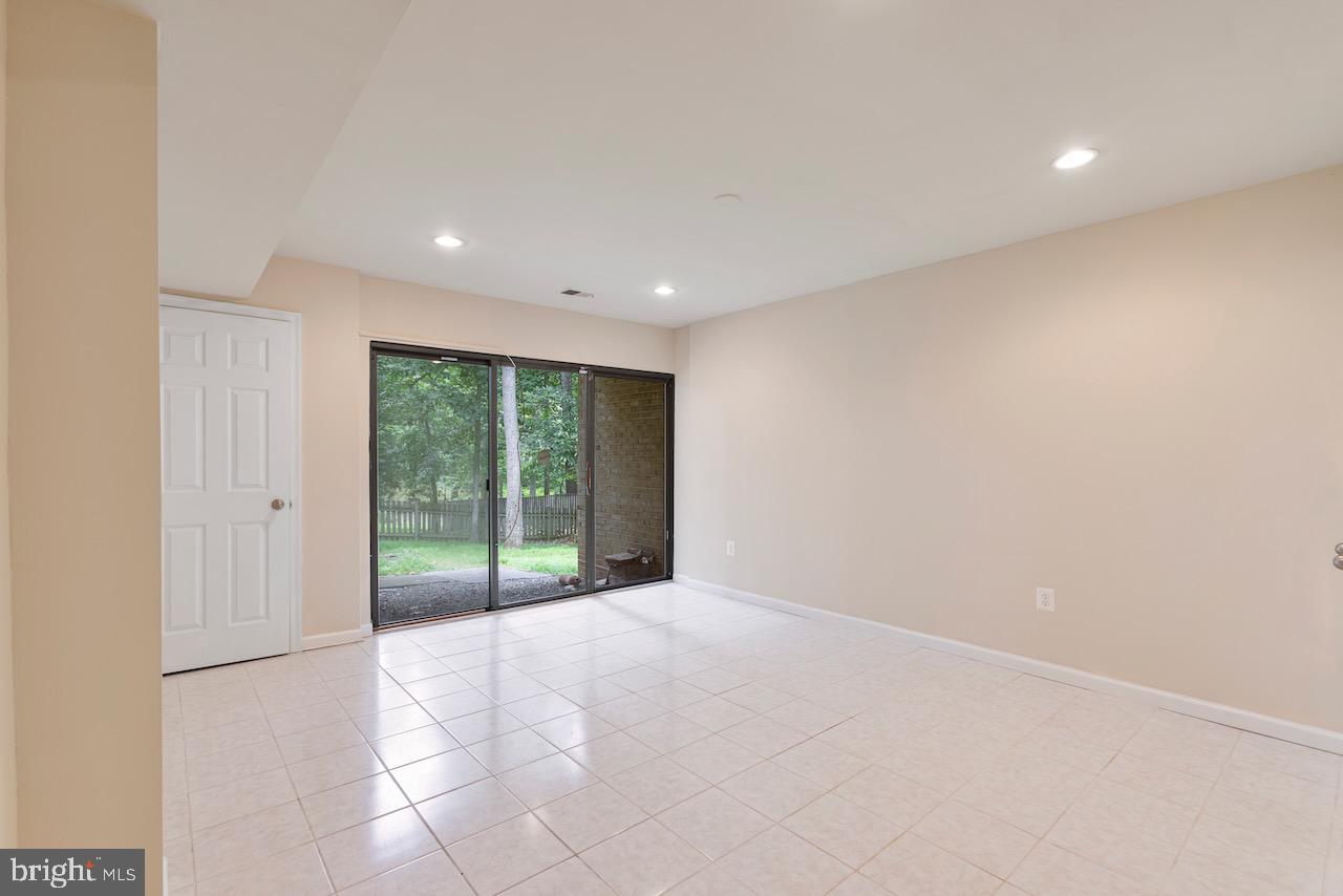 1404 Wolftrap Run Road Vienna, VA 22182 - Photo 25 of 33 Lower Level rec room with sliding glass door
