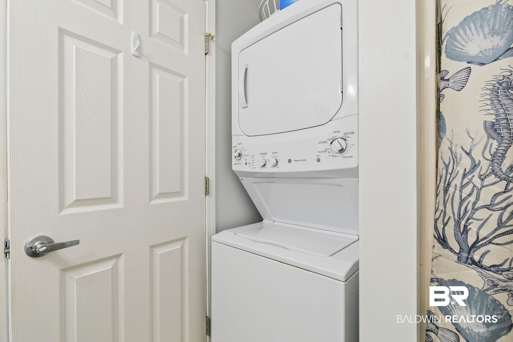25861 Canal Road, Unit 78 Orange Beach, AL 36561 - Photo 22 of 45 Washroom featuring laundry area and stacked washing maching and dryer