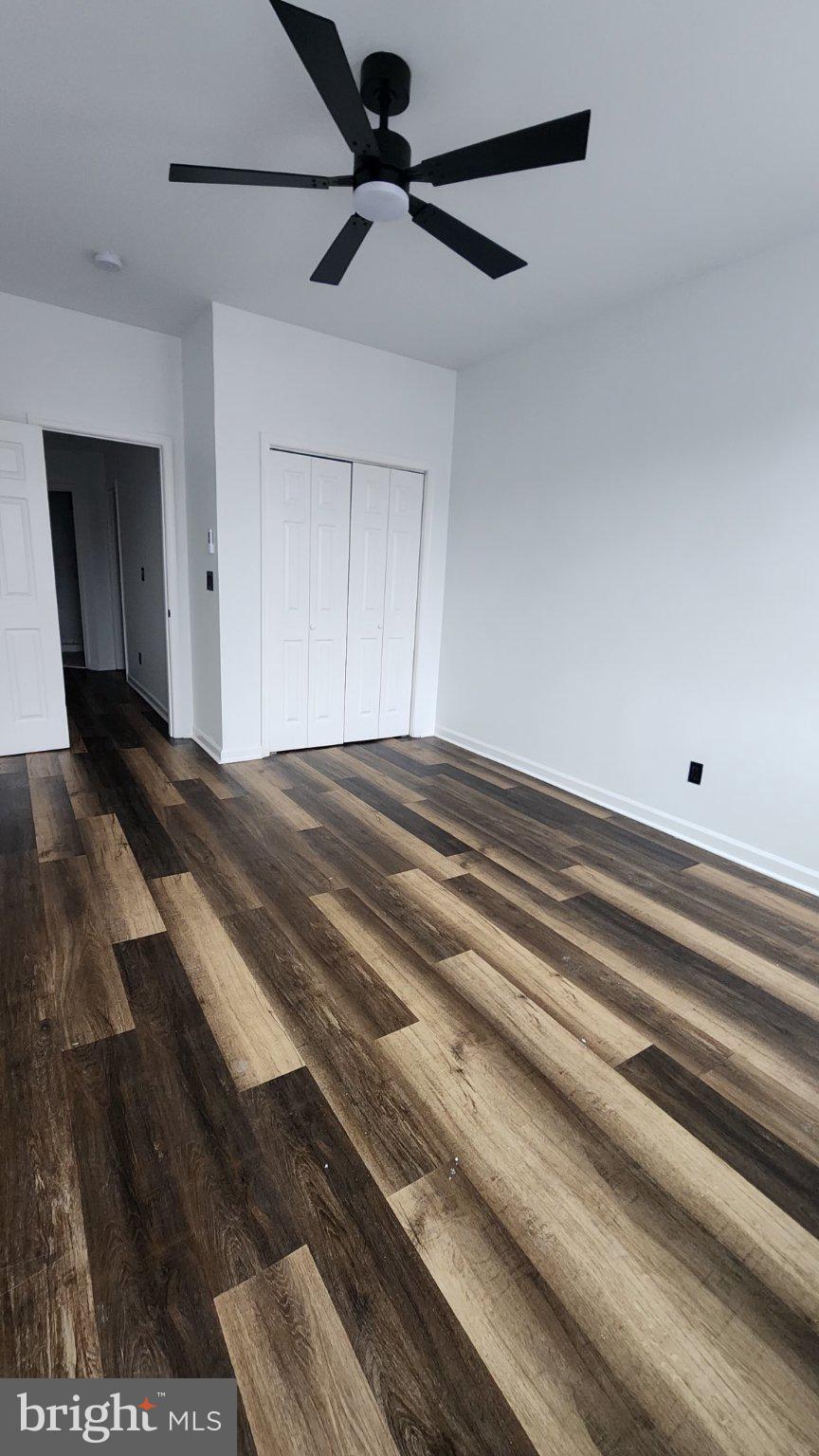 3502 East Lombard Street Baltimore, MD 21224 - Photo 4 of 10 a view of a ceiling fan and wooden floor