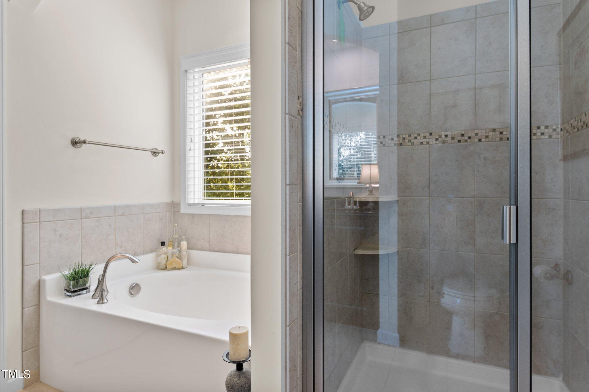 5657 Wade Park Boulevard Raleigh, NC 27607 - Photo 12 of 24 Primary Bathroom with a walk-in shower and soaking tub.