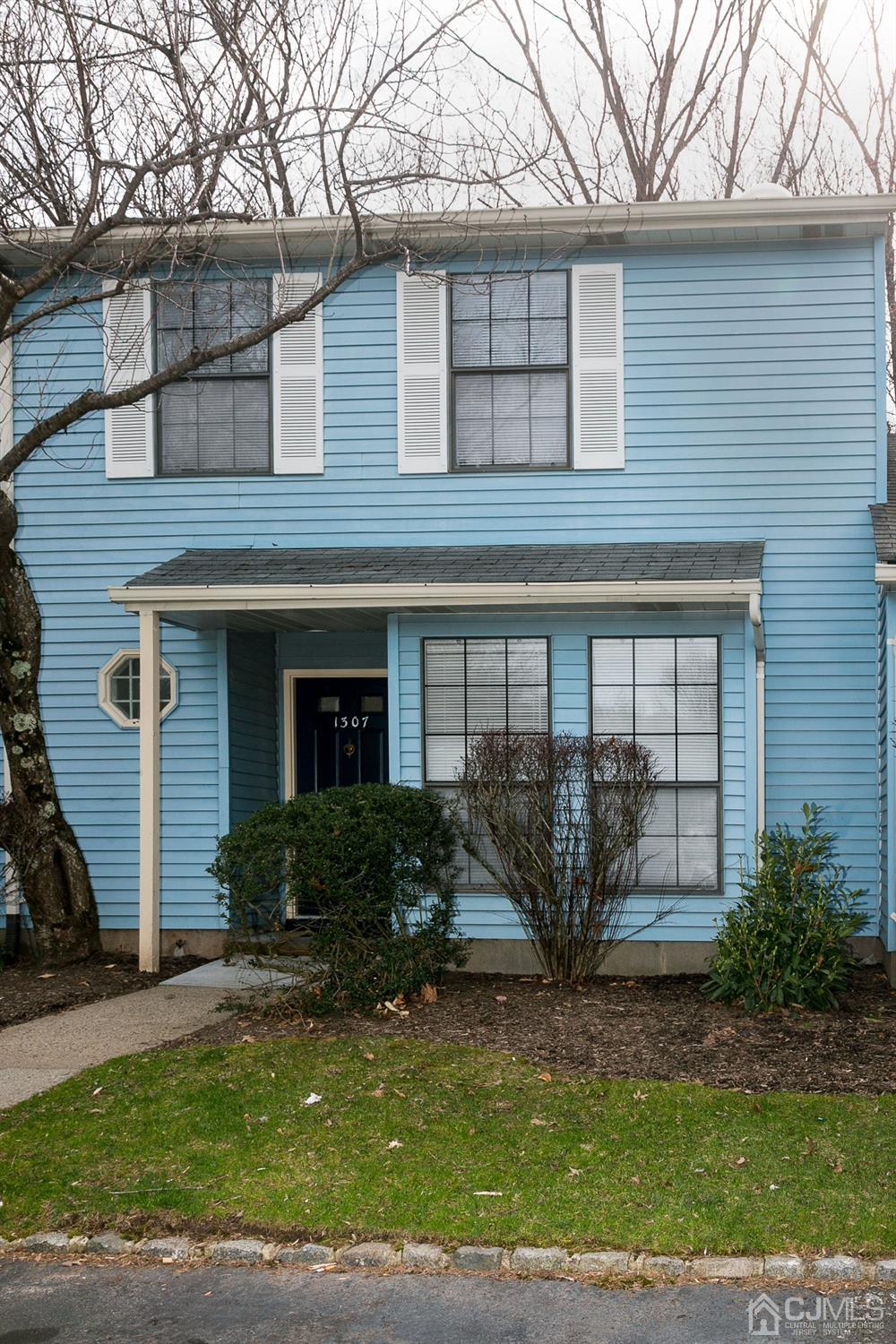 1307 Timber Oaks Road Edison, NJ 08820 - Photo 2 of 26 a front view of a house with garden