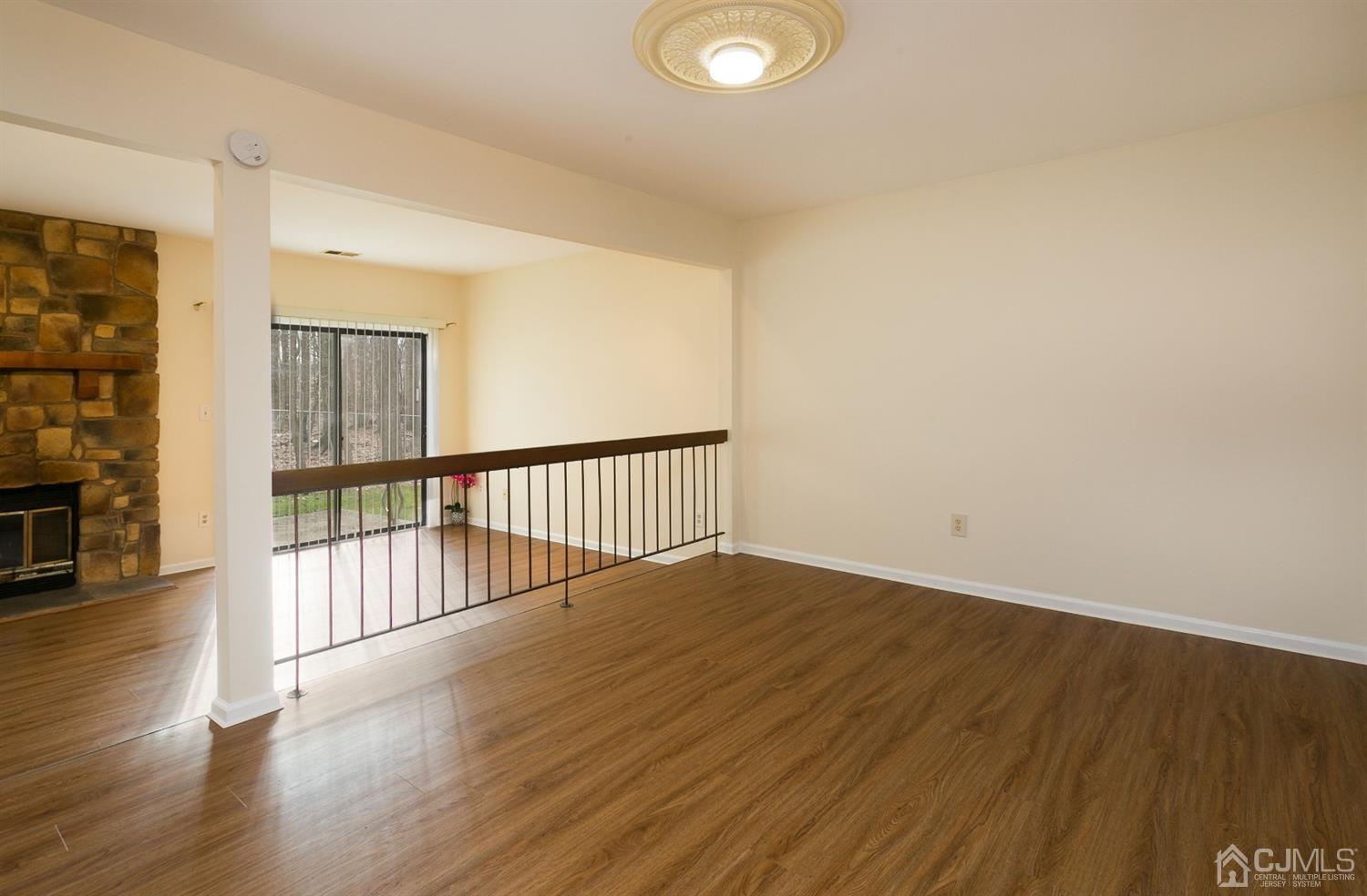 1307 Timber Oaks Road Edison, NJ 08820 - Photo 12 of 26 a view of an empty room with wooden floor