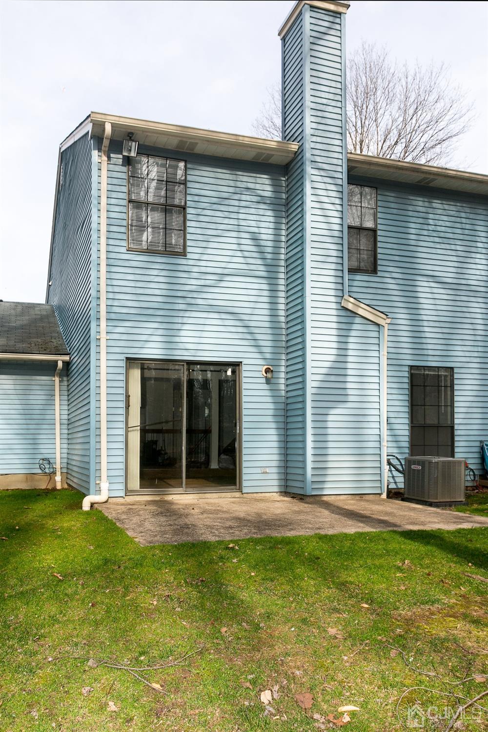 1307 Timber Oaks Road Edison, NJ 08820 - Photo 4 of 26 a front view of a house with a yard