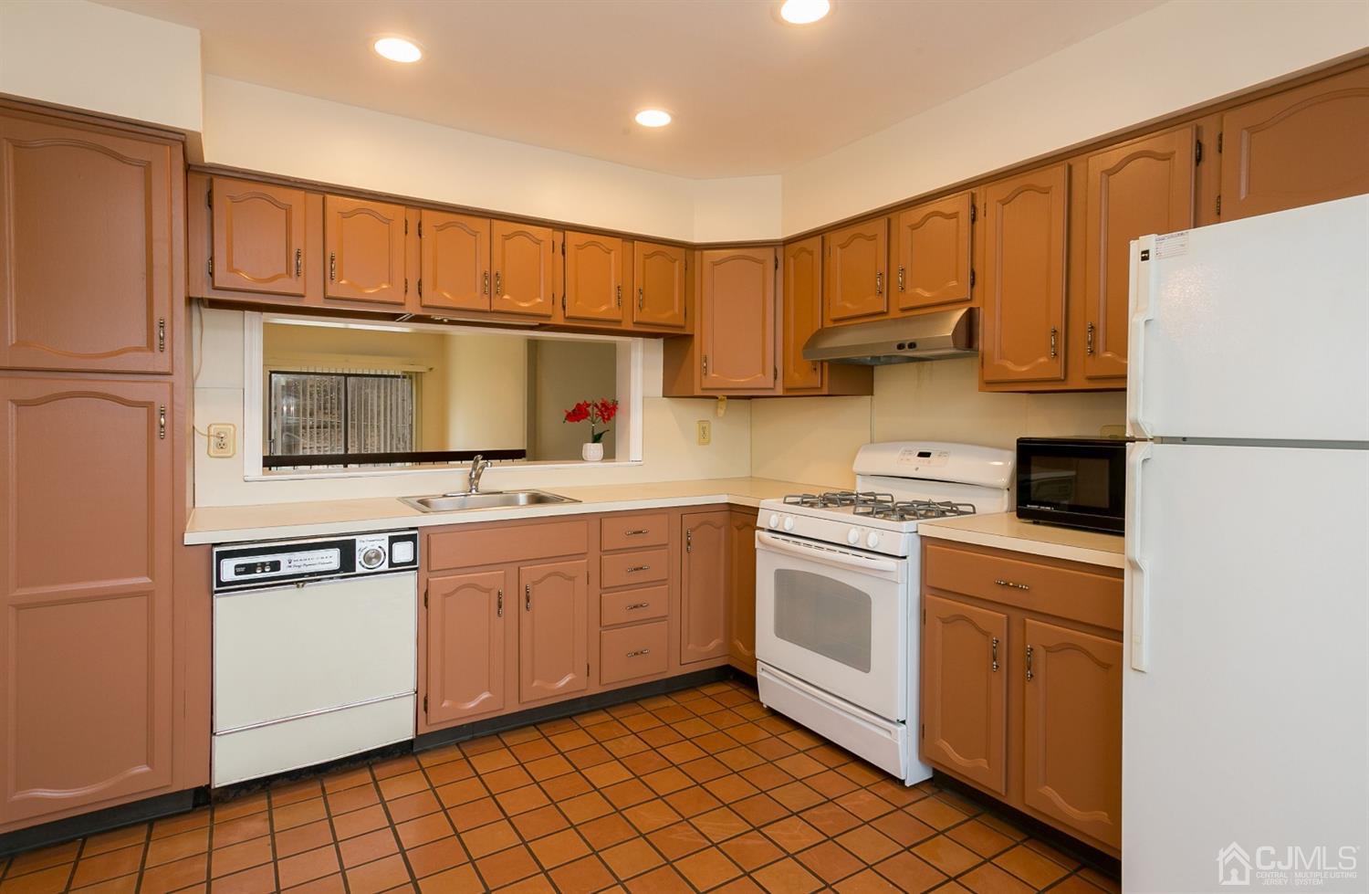 1307 Timber Oaks Road Edison, NJ 08820 - Photo 9 of 26 a kitchen with stainless steel appliances granite countertop a refrigerator sink stove and white cabinets