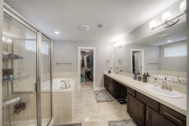 a white bath tub sitting next to a shower