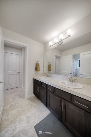 a view of patio with a table and chairs under an umbrella with a small yard