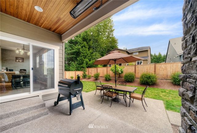 a view of a house with backyard and sitting area