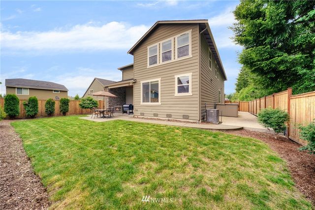 an aerial view of a house with garden space and street view