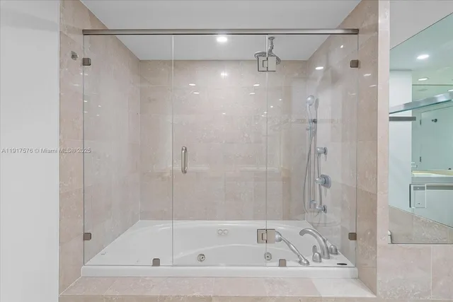 a bathroom with a bathtub and a shower