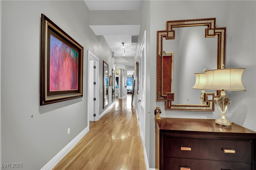 360 East Desert Inn Road, Unit 1803 Las Vegas, NV 89109 - Photo 17 of 67 Hallway featuring light wood-type flooring and baseboards