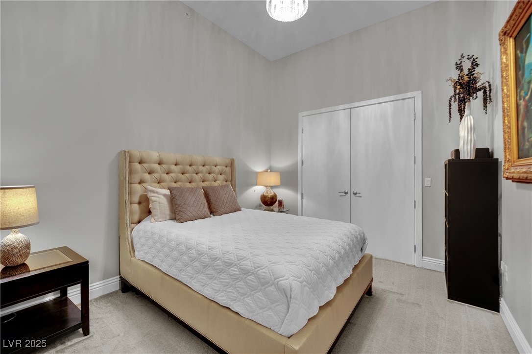 360 East Desert Inn Road, Unit 1803 Las Vegas, NV 89109 - Photo 18 of 67 Bedroom with light carpet, baseboards, and a closet