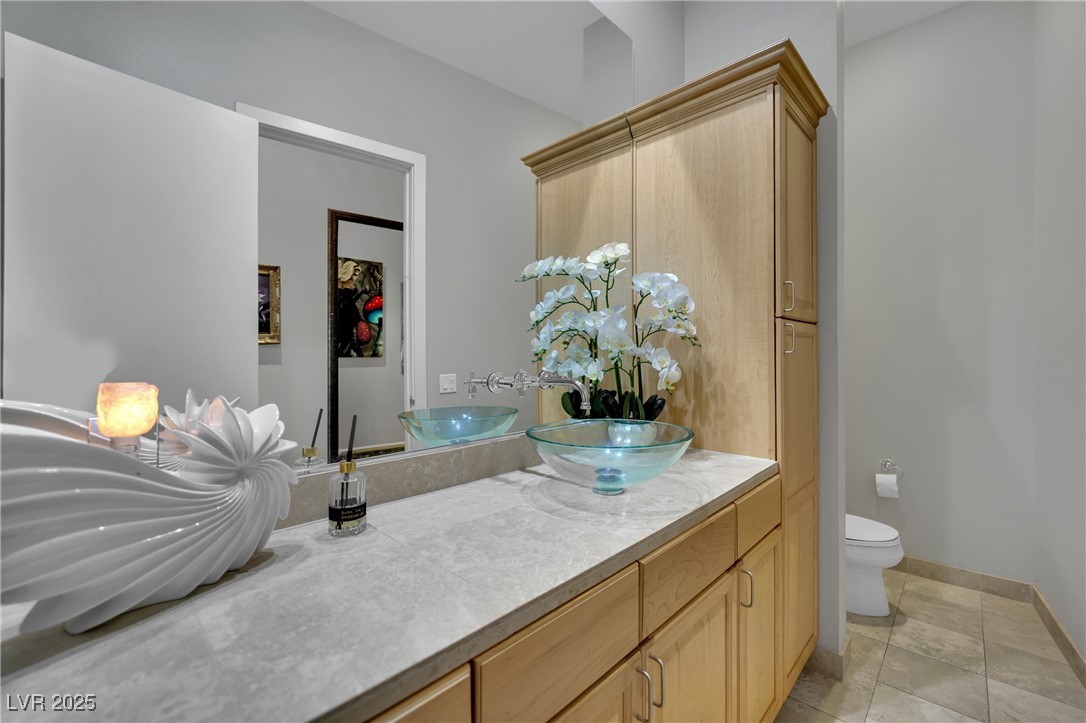 360 East Desert Inn Road, Unit 1803 Las Vegas, NV 89109 - Photo 22 of 67 Bathroom featuring vanity, toilet, and baseboards