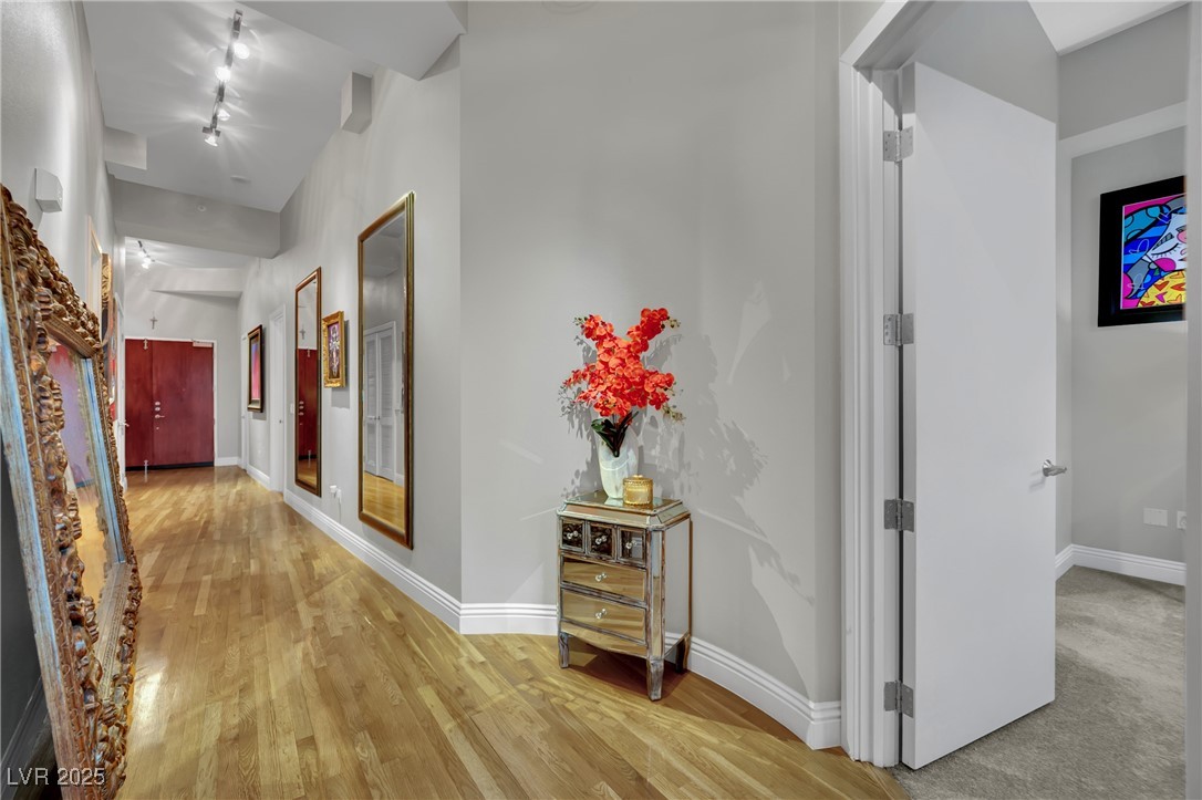 360 East Desert Inn Road, Unit 1803 Las Vegas, NV 89109 - Photo 24 of 67 Hall featuring baseboards, light wood-style floors, and track lighting