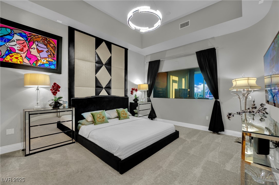 360 East Desert Inn Road, Unit 1803 Las Vegas, NV 89109 - Photo 25 of 67 Carpeted bedroom with baseboards and a tray ceiling