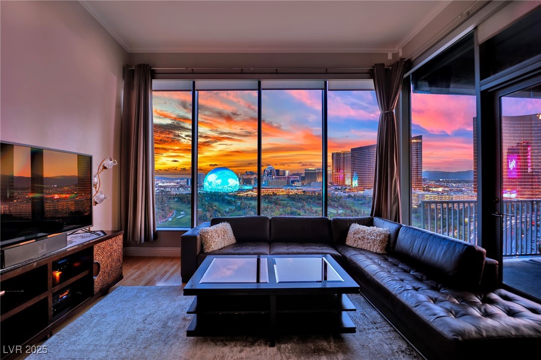 360 East Desert Inn Road, Unit 1803 Las Vegas, NV 89109 - Photo 3 of 67 Living room featuring wood finished floors, crown molding, baseboards, and a view of city