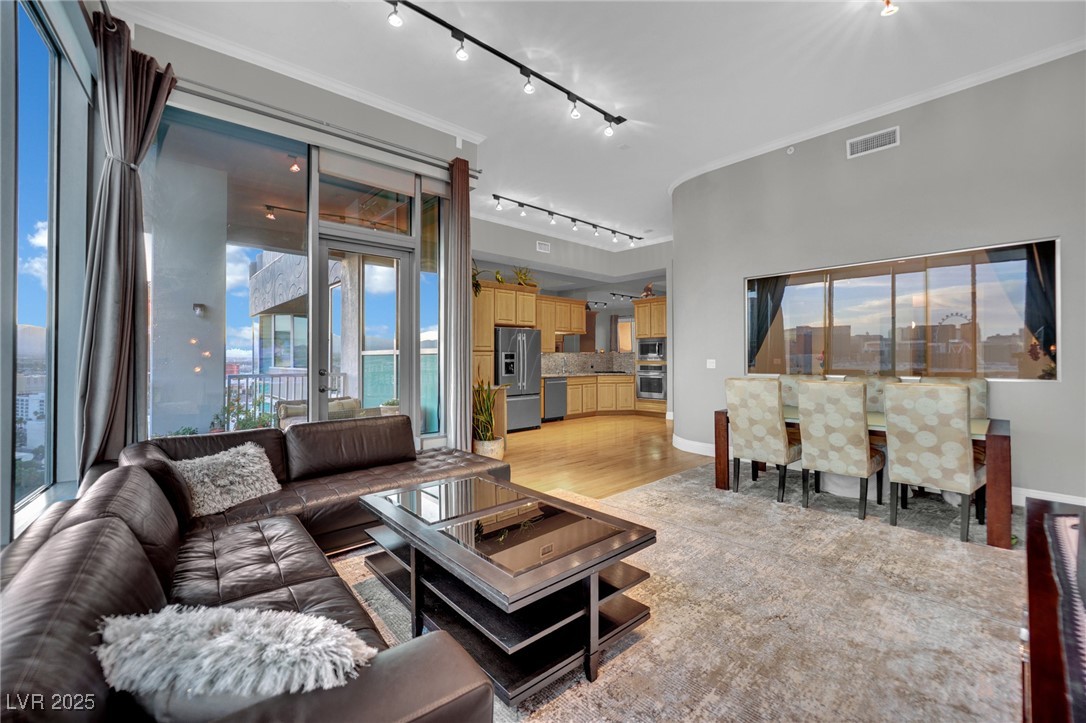 360 East Desert Inn Road, Unit 1803 Las Vegas, NV 89109 - Photo 33 of 67 Living area featuring track lighting, baseboards, light wood-style floors, and ornamental molding