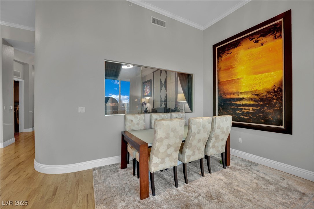 360 East Desert Inn Road, Unit 1803 Las Vegas, NV 89109 - Photo 36 of 67 Dining space with crown molding, baseboards, and wood finished floors