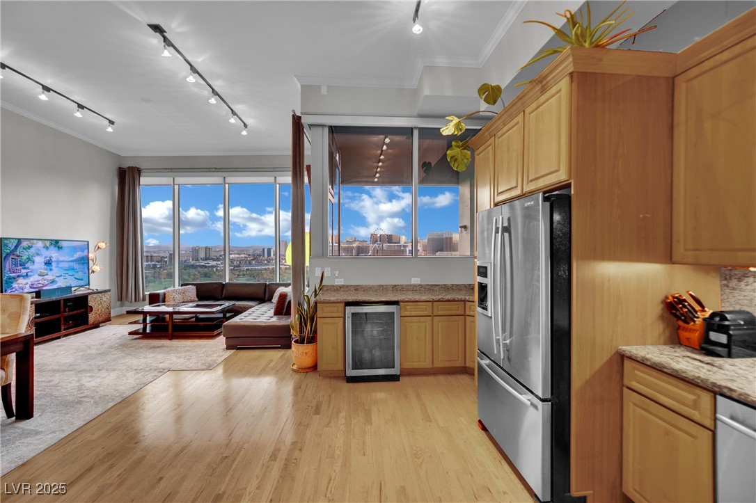 360 East Desert Inn Road, Unit 1803 Las Vegas, NV 89109 - Photo 67 of 67 Kitchen with wine cooler, stainless steel appliances, open floor plan, crown molding, and light wood-style floors