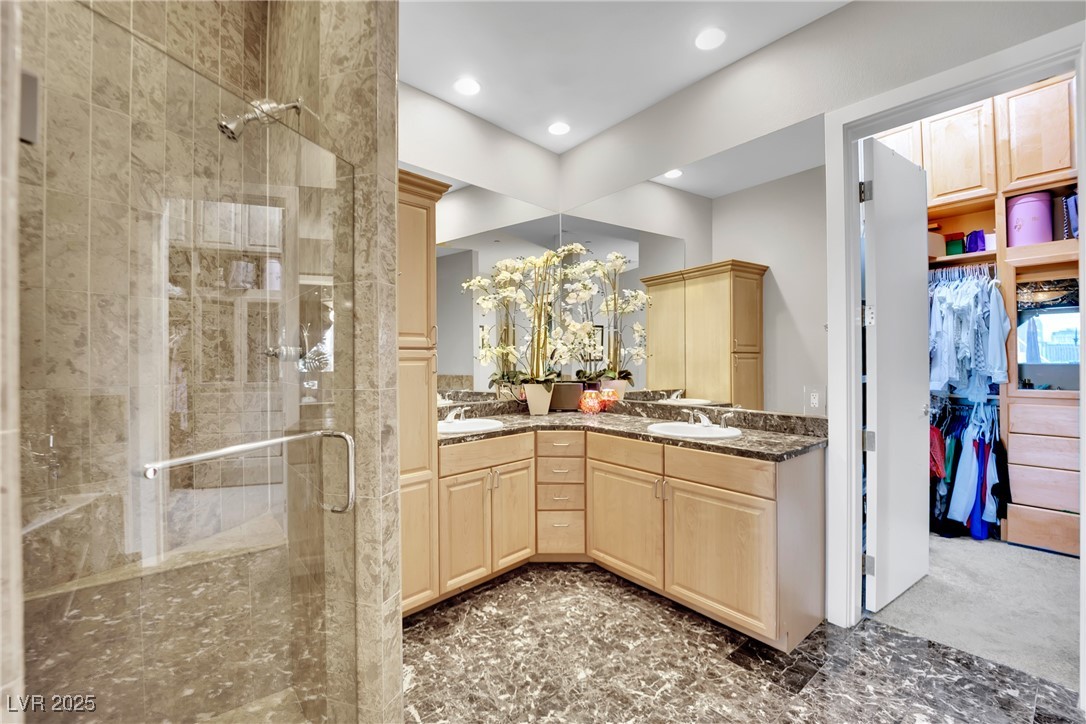 360 East Desert Inn Road, Unit 1803 Las Vegas, NV 89109 - Photo 46 of 67 Bathroom featuring a stall shower, double vanity, recessed lighting, and a walk in closet