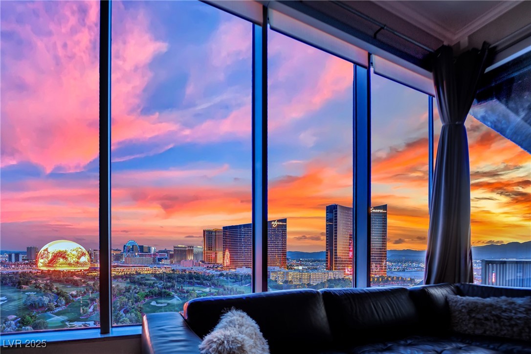 360 East Desert Inn Road, Unit 1803 Las Vegas, NV 89109 - Photo 7 of 67 Living area with a view of city and crown molding