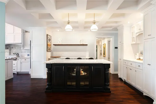 a large kitchen with a stove and wooden floor
