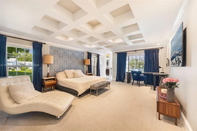 a bedroom with furniture and a large window