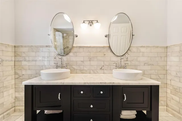 a bathroom with a double vanity sink and a mirror