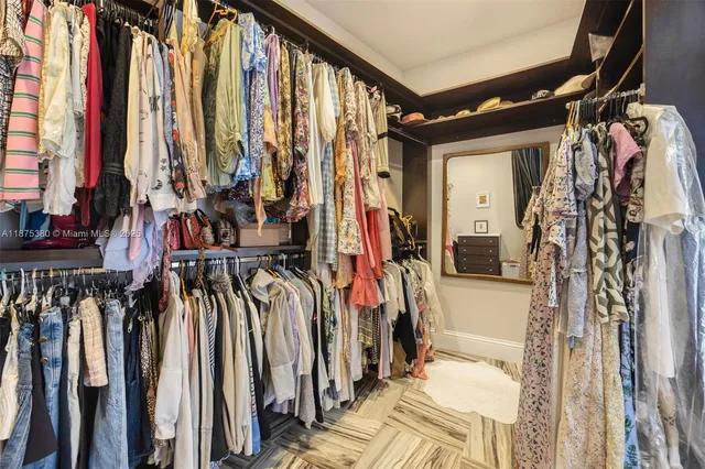 a view of walk in closet with clothes