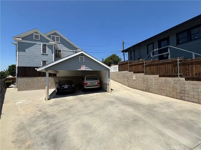 a view of house with outdoor space and parking