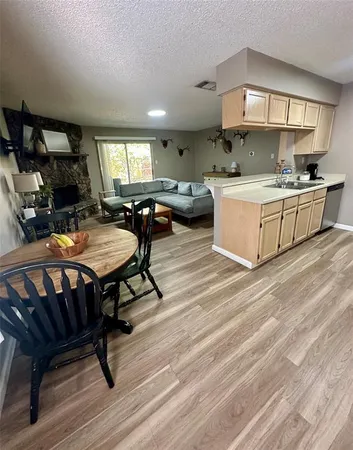 a living room with furniture a pool table and a fireplace
