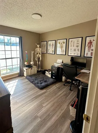 a bedroom with a bed window and a desk